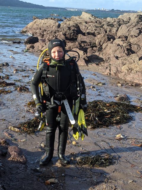 Young scuba diver ready to get in water in Devon as part of homeschooling