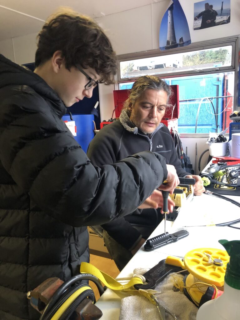 Learning basic dive kit servicing as part of kids club