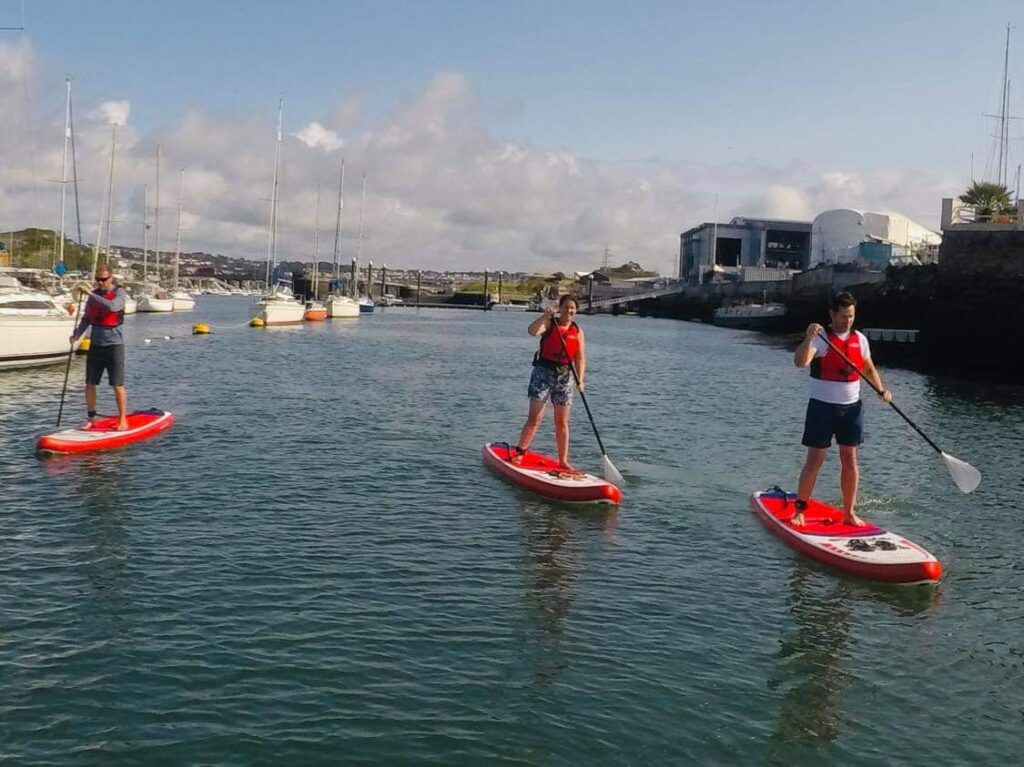 paddleboarders on the water in Plymouth